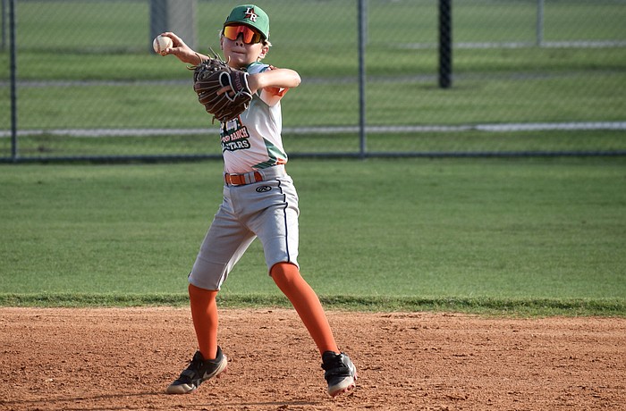 Henry Wainscott eyes first base with his throw during an around-the-horn drill at July 21 practice. He was one of 12 players who made up the 11U All-Stars — a team which finished 7-1 this summer.