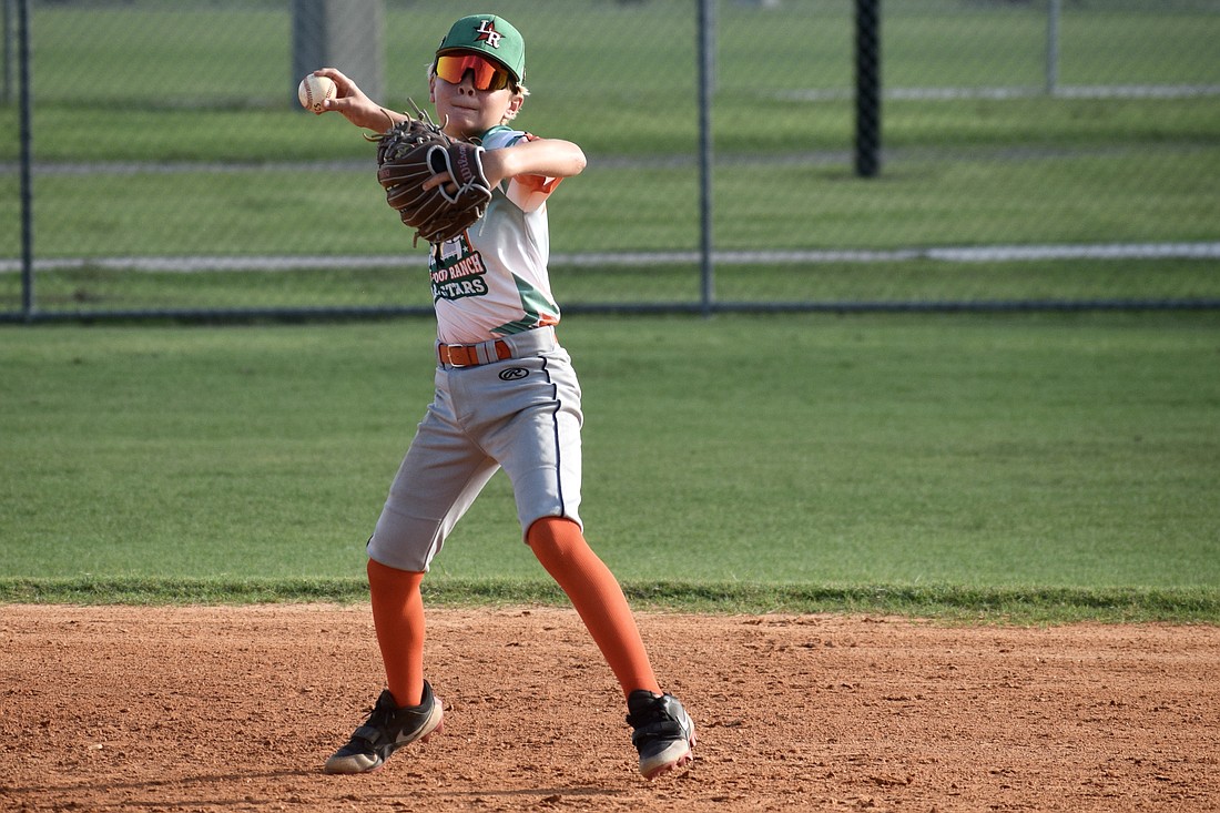 Henry Wainscott eyes first base with his throw during an around-the-horn drill at July 21 practice. He was one of 12 players who made up the 11U All-Stars — a team which finished 7-1 this summer.