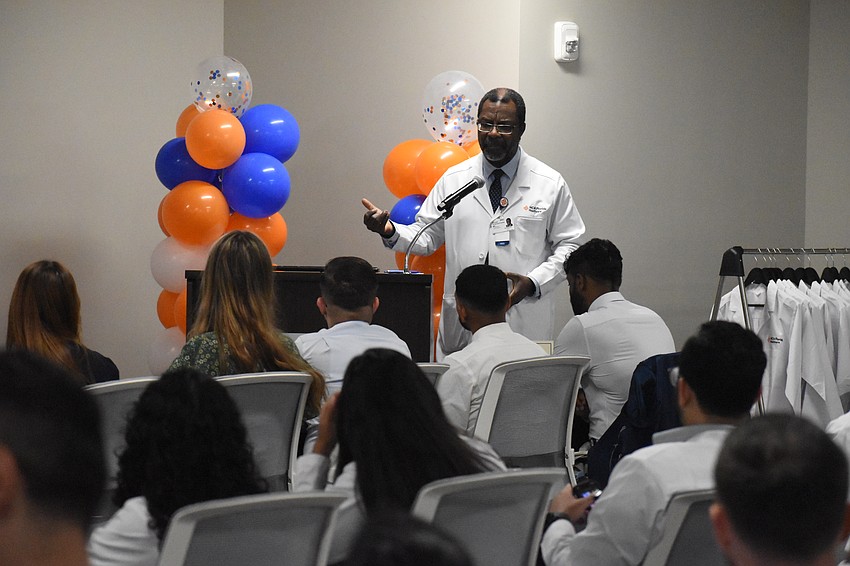 Dr. Michael Schandorf-Lartey, program director of internal medicine, speaks to resident physicians during a White Coat Ceremony for new physicians at HCA Florida Sarasota Doctors Hospital.