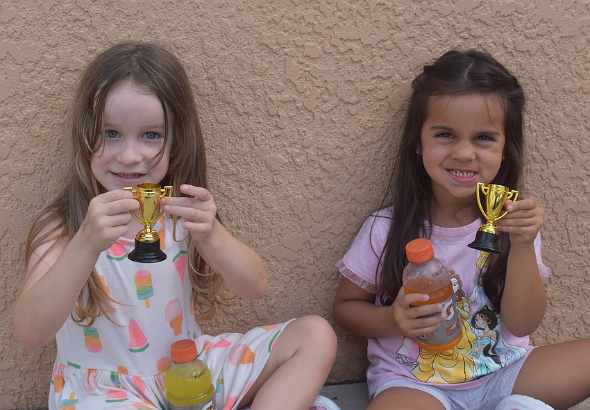 East County's Natalie Perez and Emily Fernandez-Poritz, both 4 years old, show off their trophies.