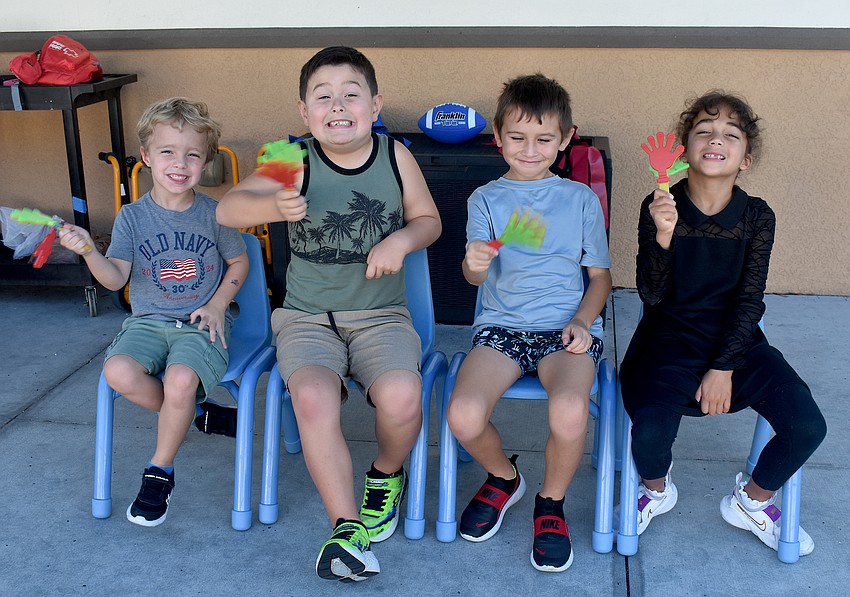 Carsen Sherrier, Harrison Ramsey, Sasha Frias and Olivia Taveras wait to cheer on their younger friends at The Learning Experience.