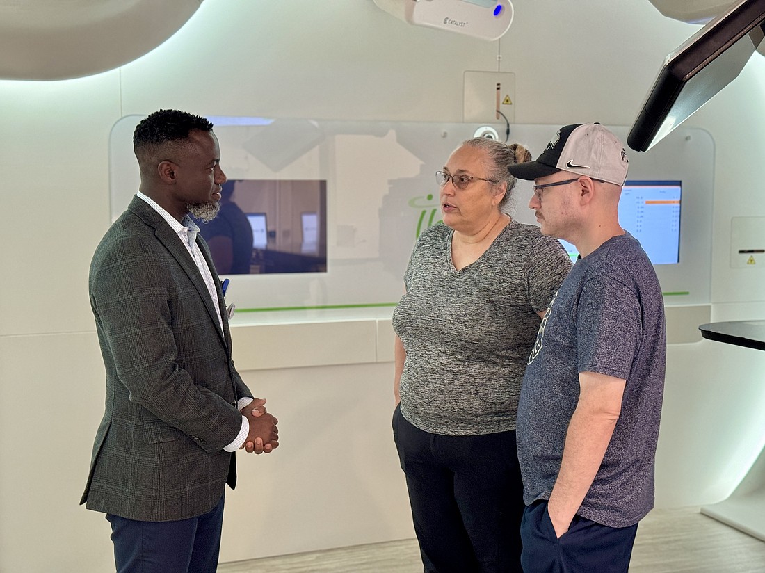 Alex Shaffer, in the baseball cap, with his mother Cindy and Dr. Kosj Yamoah, the chair of Moffitt Cancer Center's radiation oncology department.