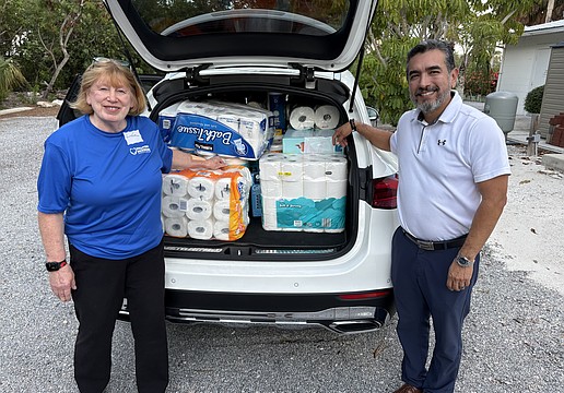 Linda Berman and Javier Chero, board members with Stillpoint Mission, pack their car to the brim with donations of toilet paper for one of Longboat Island Chapel's most popular charity drives. Even more rolls were waiting.