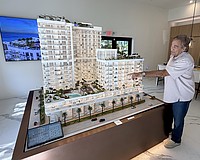 Larry Debb of GSP Development with a scale model of Saravela at the development's sales center.