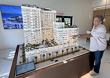 Larry Debb of GSP Development with a scale model of Saravela at the development's sales center.