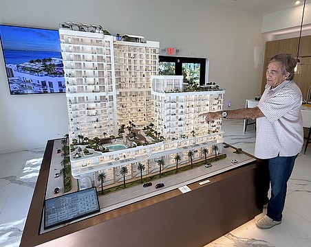 Larry Debb of GSP Development with a scale model of Saravela at the development's sales center.