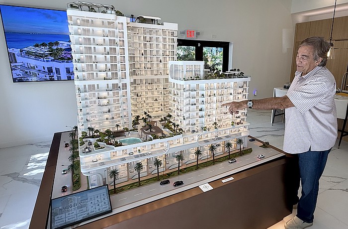 Larry Debb of GSP Development with a scale model of Saravela at the development's sales center.