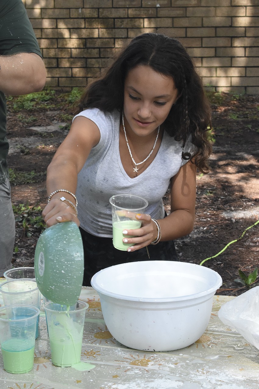 Carmen Moreira, 11, mixes liquid chalk.