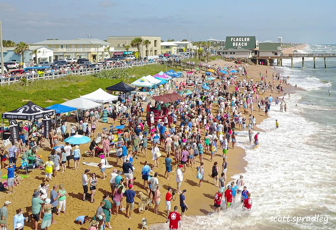 Crowds gather along the shoreline near the Flagler Beach Pier during a busy beach day. County and Flagler Beach officials are moving forward with plans for the Reach 2 beach renourishment project, which would extend from North 7th Street to Varn Park. Photo by Scott Spradley.