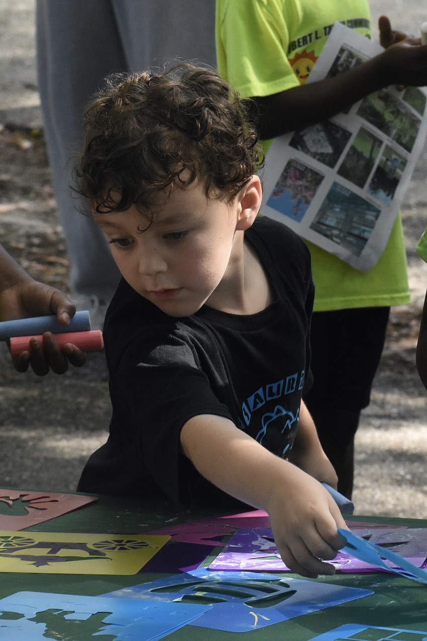 Theodore Mirochnik, 6, selects a stencil.