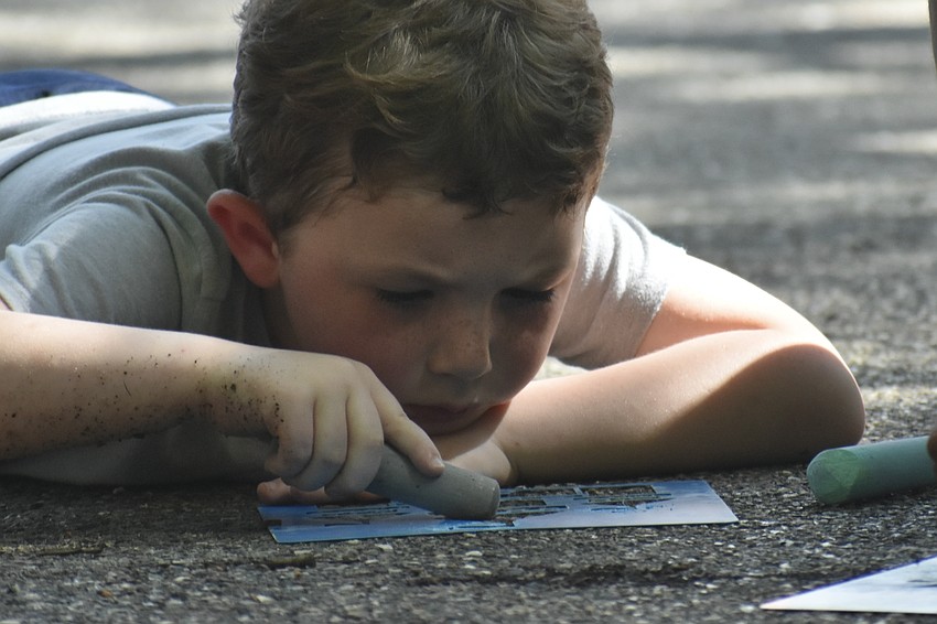 Wyatt Morris, 5, works on a stencil drawing.