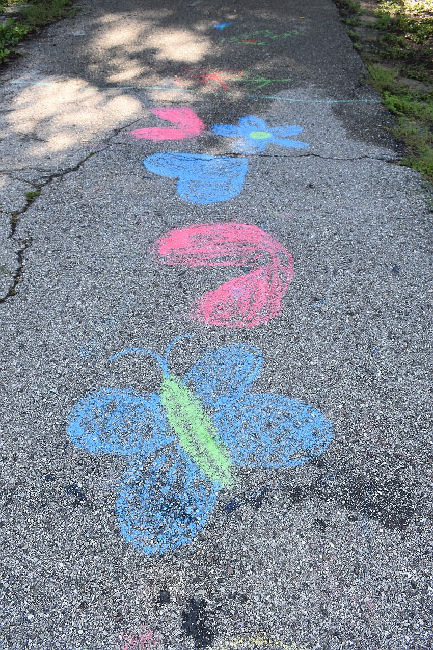 Chalk drawings from kids adorn the trail.