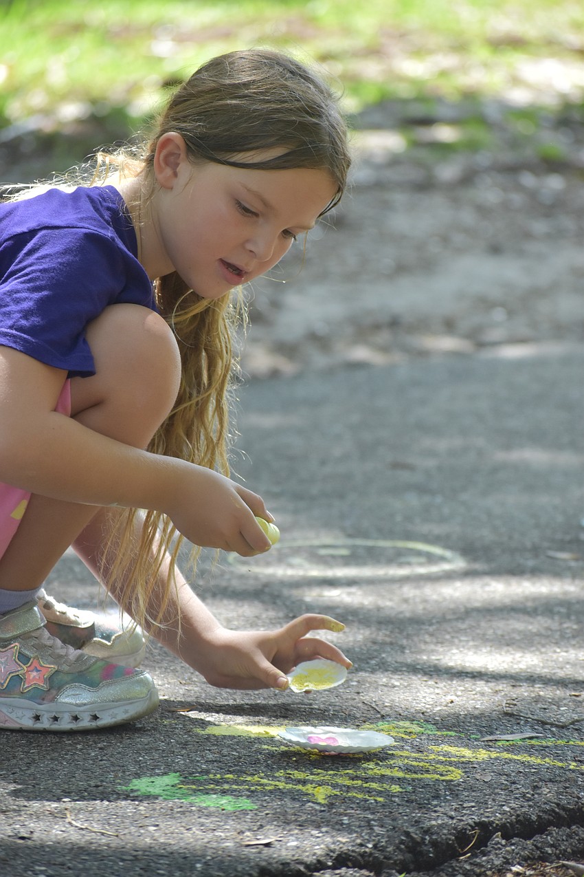 Alexandra Schutz, 8, paints shells with liquid chalk.