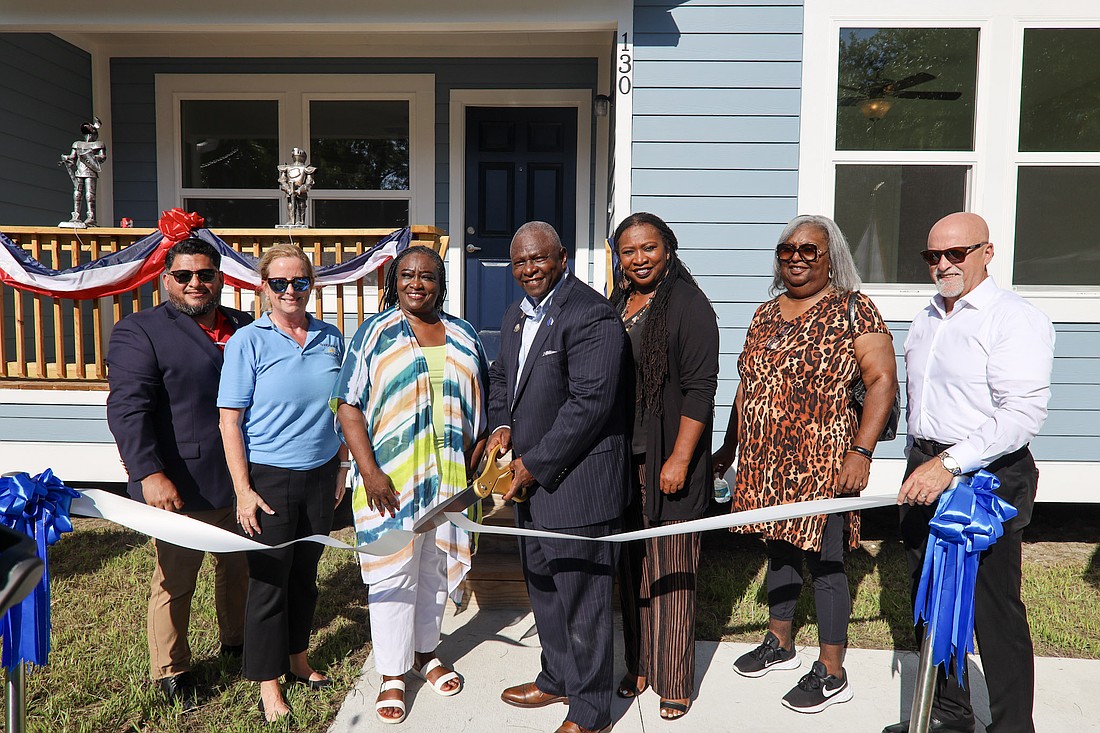 Pierre Louis cuts the ribbon on his newly reconstructed home rebuilt through Volusia County's Transform386 Homeowner Recovery Program. Courtesy photo