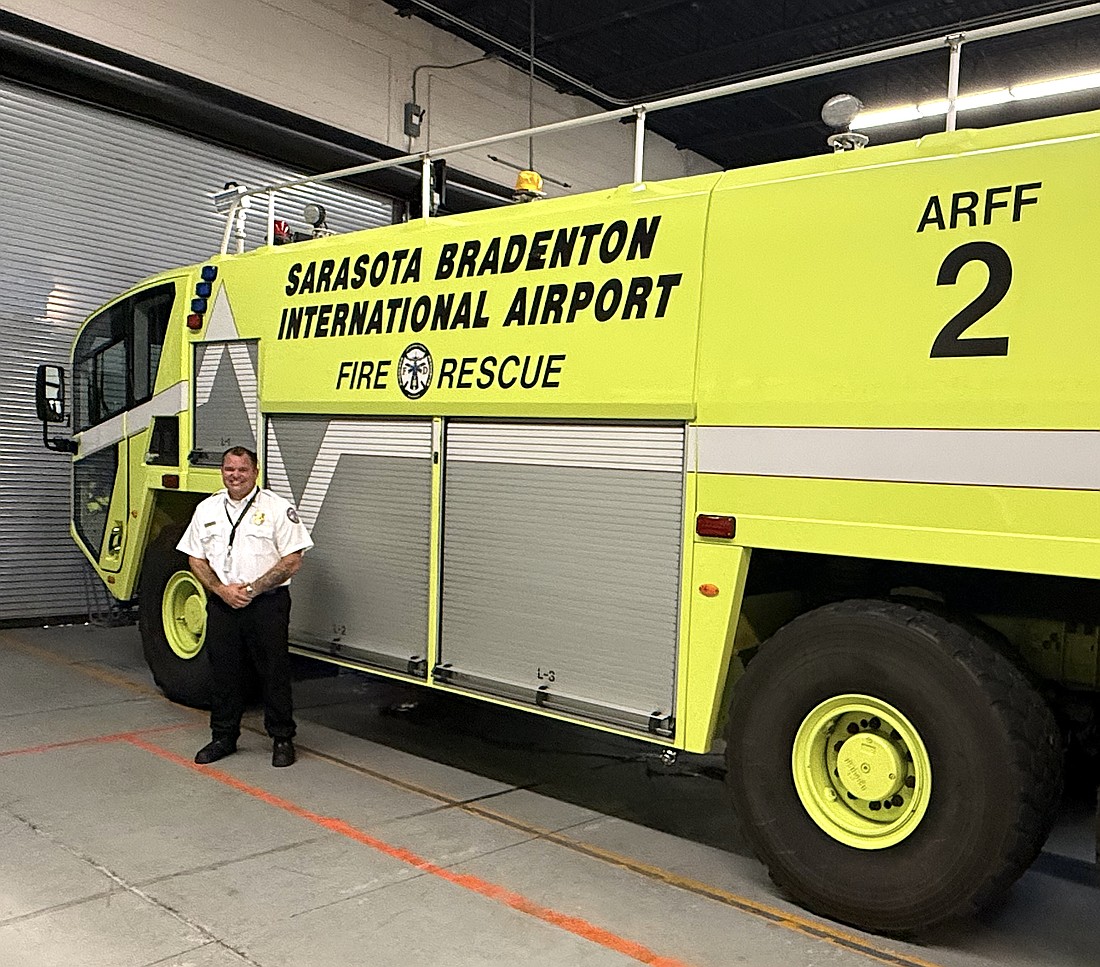 Sarasota-Bradenton International Airport Fire Department Chief Jason Hackley and one of the agency's three trucks with onboard tanks that hold 400 gallons of firefighting foam.