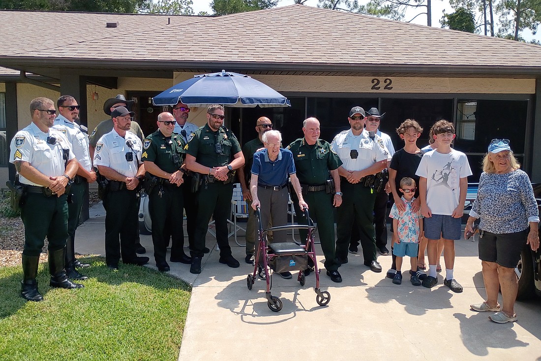 Flagler County Sheriff Rick Staly, deputies and family members helped World War II veteran Albert Smith (center) celebrate his 103rd birthday. Courtesy photo