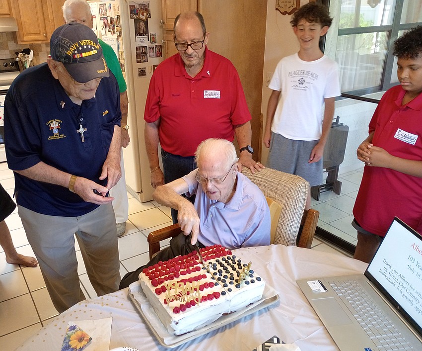 Palm Coast resident and World War II veteran Albert Smith cuts his birthday cake, courtesy of the Knights of Columbus, on his 103rd birthday. Courtesy photo Palm Coast resident and World War II veteran Albert Smith cuts his birthday cake, courtesy of the Knights of Columbus, on his 103rd birthday. Courtesy photo