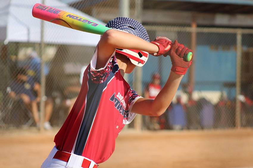 Henry D'Hondt, the son of assistant Mike D'Hondt, waits on deck before an at-bat. He first got into baseball because the sport runs in his family.