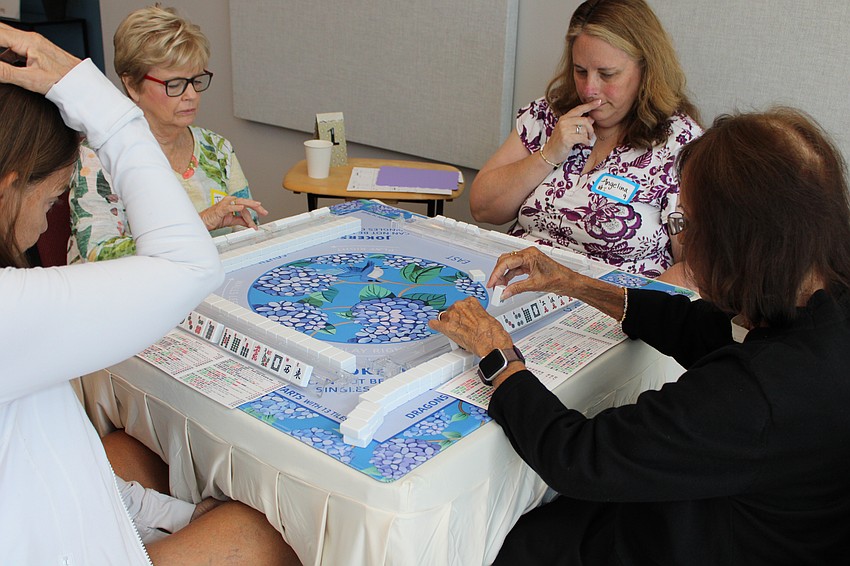 Players Lindsey Columbo, Jamie Engel, Angelina Boyce and Venette Motyl begin another round of mahjong.