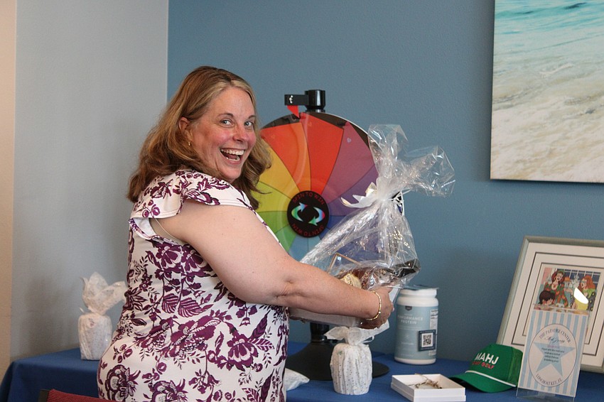 Angelina Boyce shows off her raffle prize from the Paradise Center Mah Jongg Weekend.