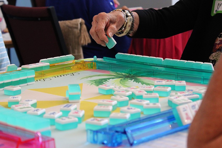 Players switched tables and opponents every round, so they got a chance to meet new people and play with different sets.