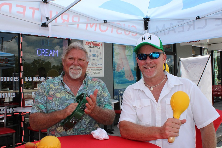 Dale Ashley and Adam Waxler enjoy the steel drum Christmas music outside 1 HotCookie and Ice Cream.