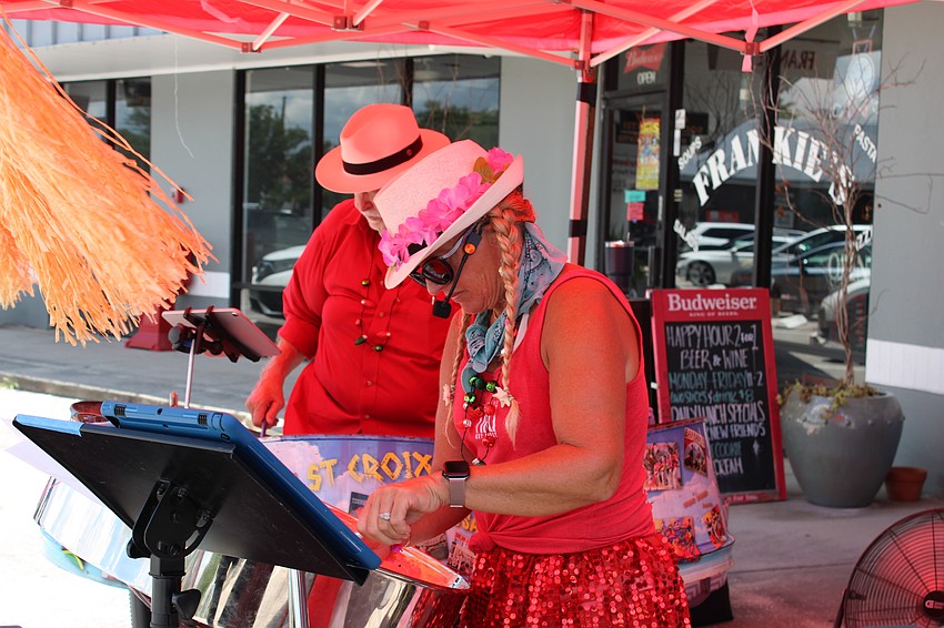 Stasea Conery and Dave Naumann (Captain Dave, the Pan Man) play Christmas music in celebration of Christmas in July.