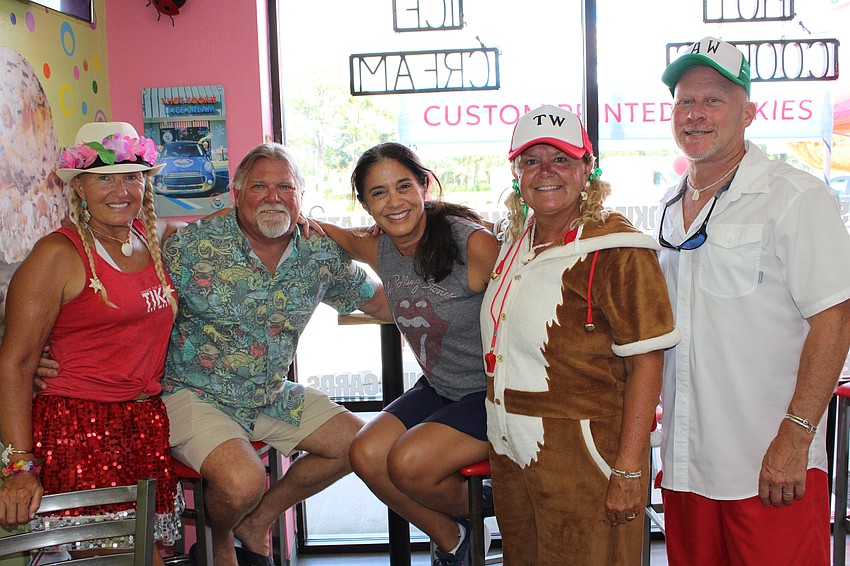 Stasea Conery, Dale Ashley, Tracey Panzone, Tanya Waxler and Adam Waxler smile while in their tropical Christmas attire.