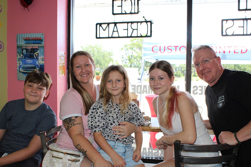 Sawyer Hochstetler, 10, Brittany Mccray, Lennon Wlson, 7, Karis Hochstetler, 13 and Shawn Mccray enjoy cookies and ice cream at the Christmas in July celebration.