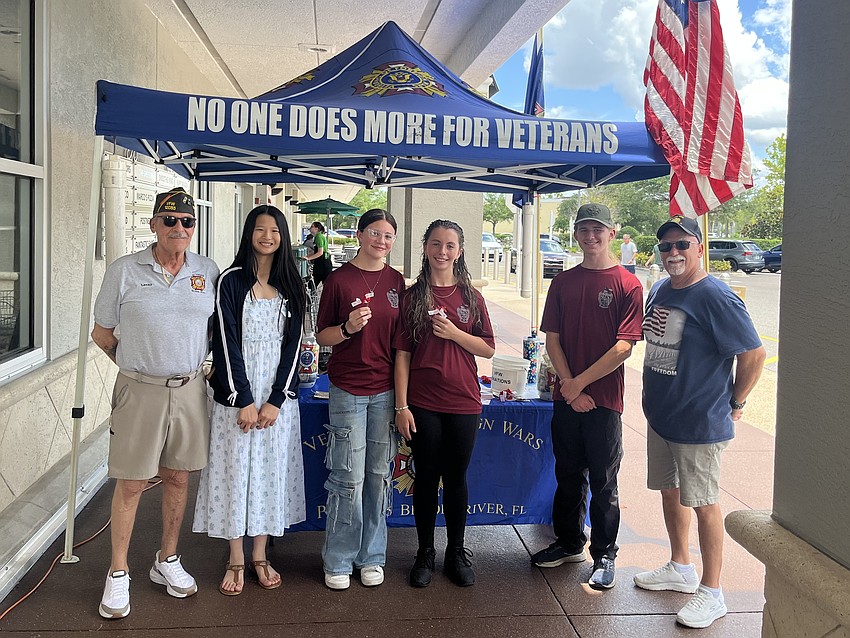 Post Member Lenny DeRasmo (left) and Post Commander Dave Daily (right) volunteer alongside Braden River High School students Sofia Lu, Coraline Goldman, Tialahni Hallman and Agustus Secord during a Buddy Poppy fundraiser on May 23. Post Member Lenny DeRasmo (left) and Post Commander Dave Daily (right) volunteer alongside Braden River High School students Sofia Lu, Coraline Goldman, Tialahni Hallman and Agustus Secord during a Buddy Poppy fundraiser on May 23.