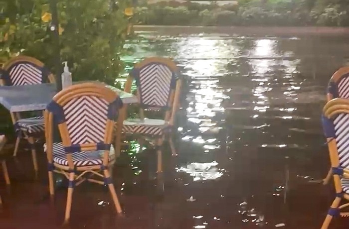 Water pooled around outdoor seating in front of Cha Cha Coconuts on the night of Thursday, July 23.