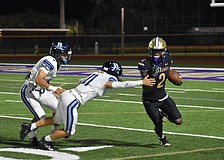 Former Booker High wide receiver Tyren Hornes (right) is pictured dodging defenders in a game against Berkeley Prep during the 2025 season. The next generation of Tornadoes will have a new coach to lead them.