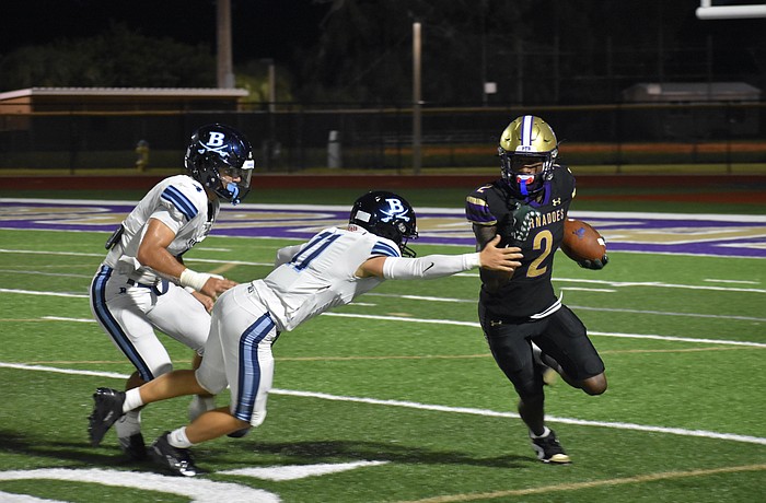 Former Booker High wide receiver Tyren Hornes (right) is pictured dodging defenders in a game against Berkeley Prep during the 2025 season. The next generation of Tornadoes will have a new coach to lead them.