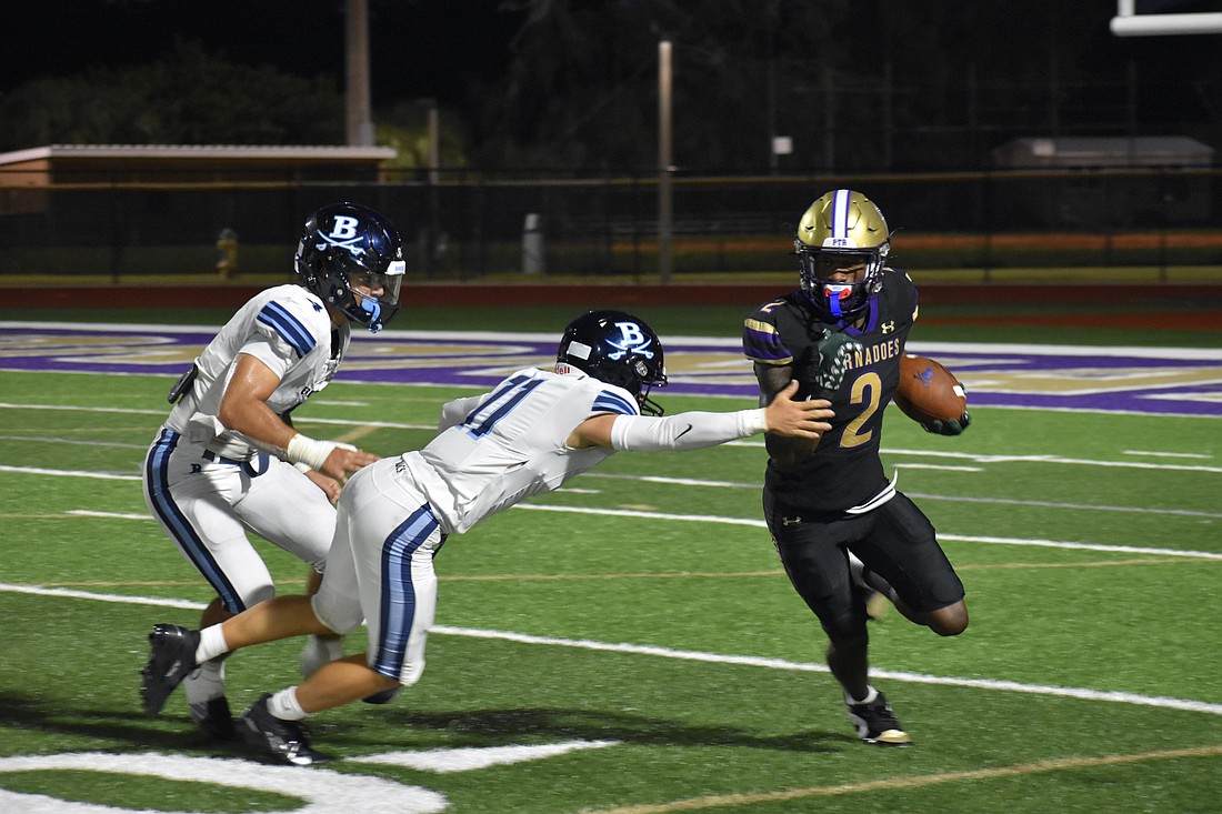 Former Booker High wide receiver Tyren Hornes (right) is pictured dodging defenders in a game against Berkeley Prep during the 2025 season. The next generation of Tornadoes will have a new coach to lead them.