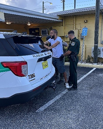 A deputy arrests Joseph Spector outside a restaurant in Bunnell, Fla., July 25, 2026.