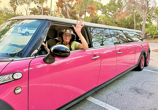 Christy James, owner of Longboat Key Flower Shop, is the driver of one of the island's most recognizable rides, a Barbie-pink limo.