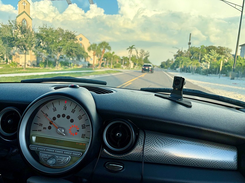 Christy James shows what her view is cruising down Gulf of Mexico Drive behind the wheel of her pink Mini Cooper.