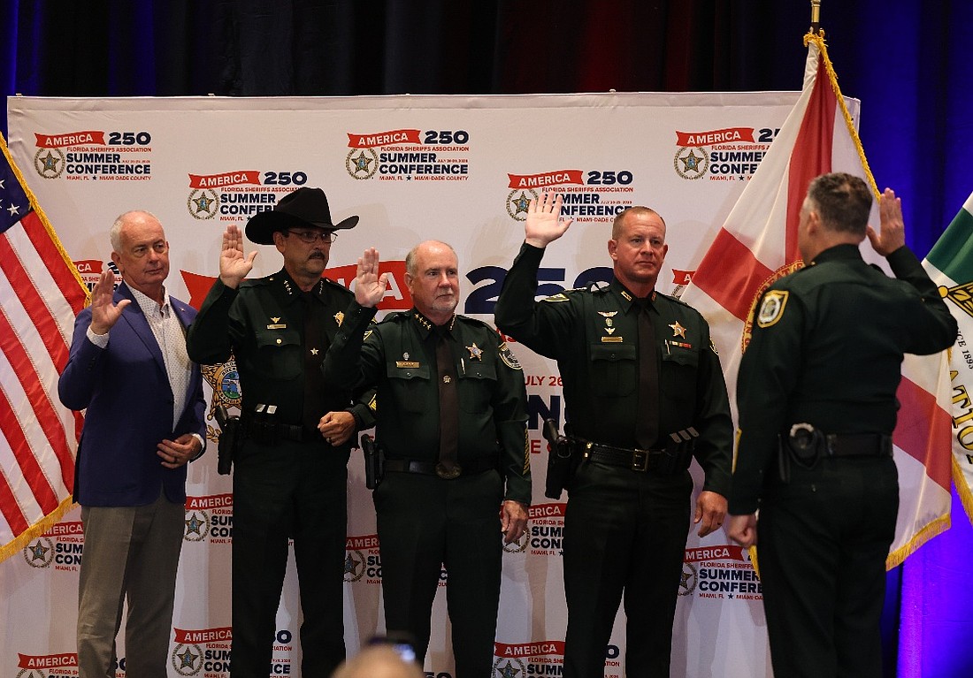 Flagler County Sheriff Rick Staly, middle, is sworn in as vice president of the Florida Sheriffs Association, alongside Franklin County Sheriff A.J. Smith as treasurer, Marion County Sheriff Billy Woods as president, and Putnam County Sheriff H.D. "Gator" Deloach III as secretary, July 28, 2026, in Miami.