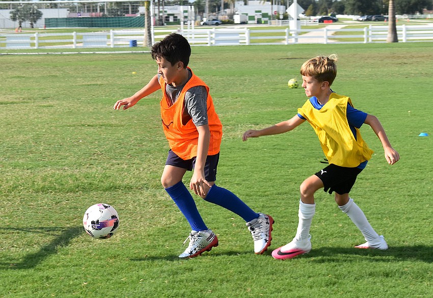 Ten-year-olds Elijah Lucas and  Cooper Lux test their speed and skills while scrimmaging at Premier Sports Campus.