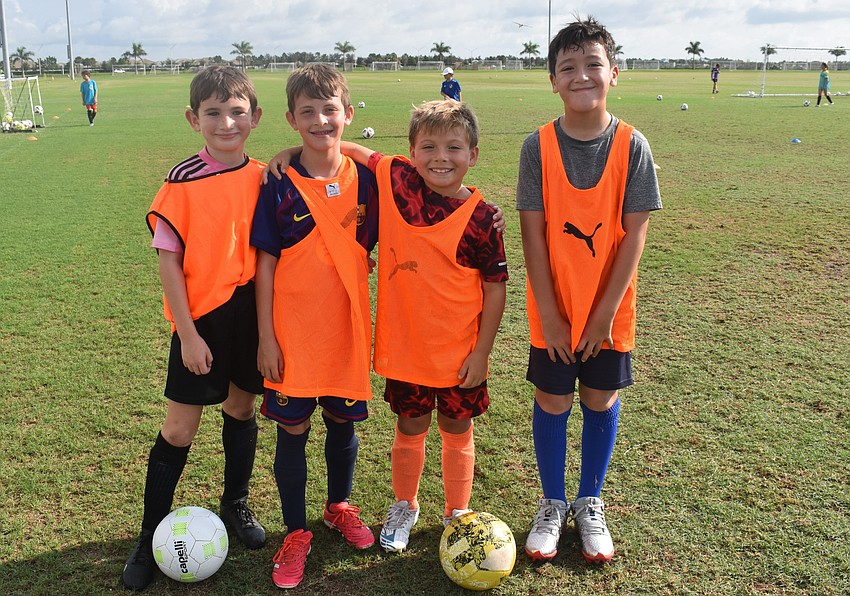 Eli Jacobs, Ryan Coppes, Ryker Krawczyk and Elijah Lucas are part of the orange team during a scrimmage at the Sarasota Paradise Summer Camp July 31.