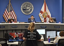 Manatee County resident Julie Madison addresses commissioners at the July 28 meeting. The black t-shirt Madison is wearing was also worn by several other residents.