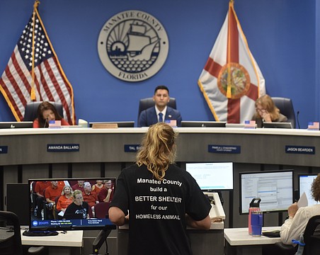 Manatee County resident Julie Madison addresses commissioners at the July 28 meeting. The black t-shirt Madison is wearing was also worn by several other residents.