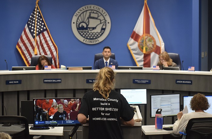 Manatee County resident Julie Madison addresses commissioners at the July 28 meeting. The black t-shirt Madison is wearing was also worn by several other residents.