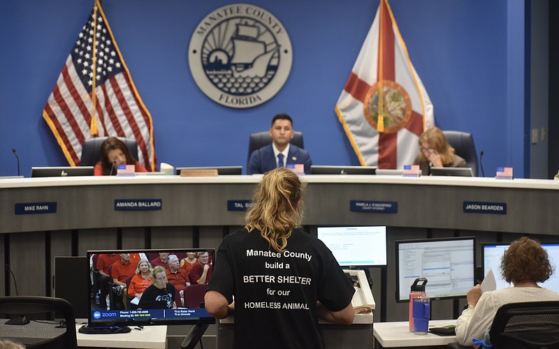Manatee County resident Julie Madison addresses commissioners at the July 28 meeting. The black t-shirt Madison is wearing was also worn by several other residents.
