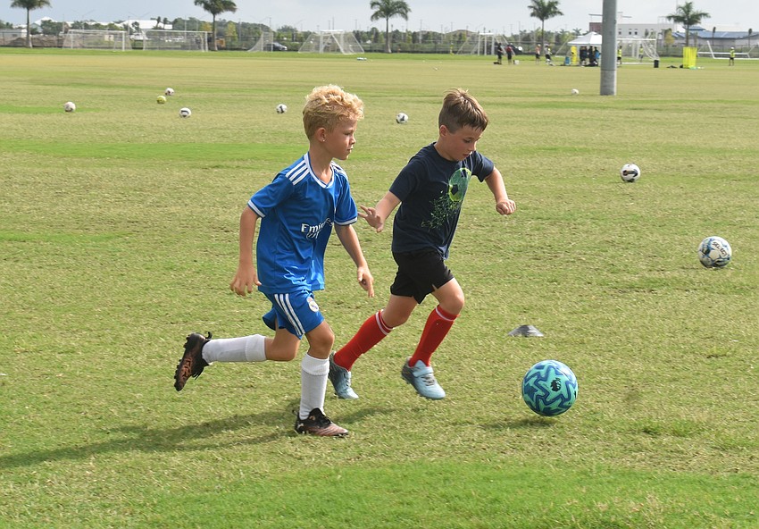 Palmer Ranch 7-year-old Liam Young and Sarasota 8-year-old Ethan Rose vie for the ball during an activity at Premier Sports Campus.