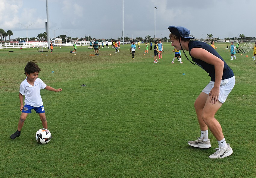 Lakewood Ranch 5-year-old Tadeo Zacnich has no fear playing soccer, even while up against his coach Jesse Roberts.