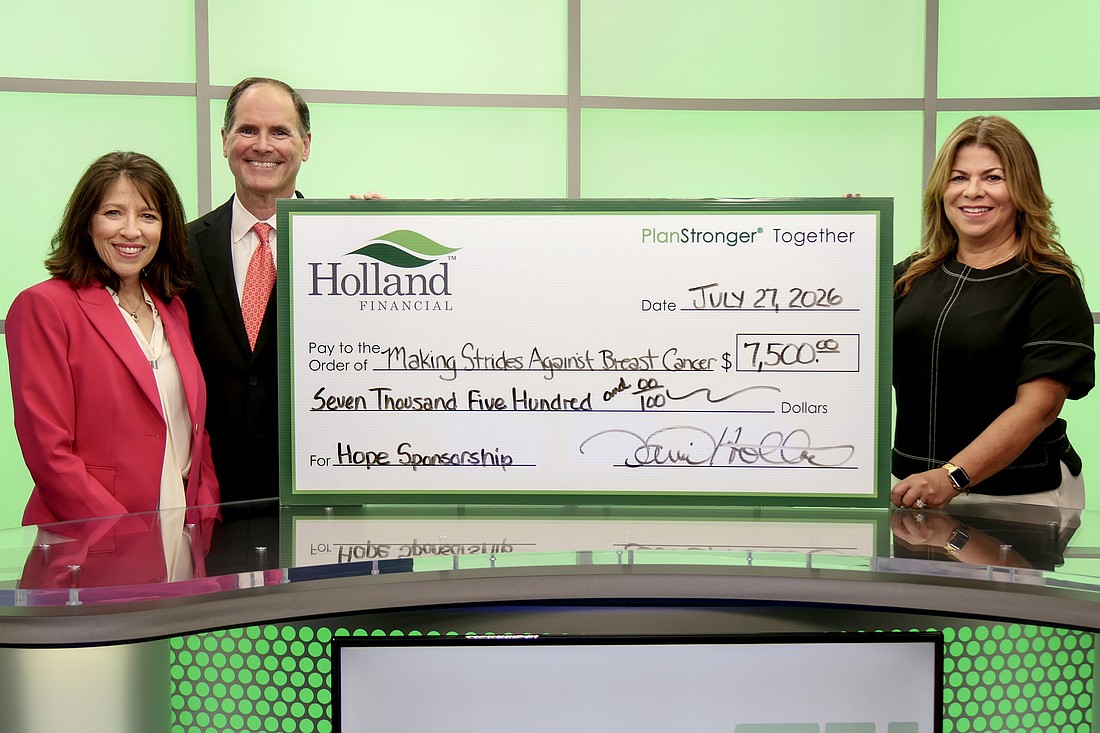 Toni and David Holland present a donation of $7,500 for the Making Strides Against Breast Cancer event to the American Cancer Society's Leslie Castillo-Soliś. Courtesy photo