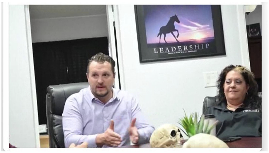 A still from a recorded sales meeting posted on LinkedIn by RAD Diversified showing RAD Diversified REIT Inc. founder Brandon "Dutch" Mendenhall (left) and co-founder Amy Vaughn (right) talking to sales agents.