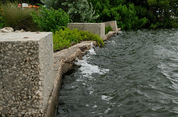 Waves lap against the weathered Bayfront Park seawall, which was installed before the town acquired the land to expand the park in 2011.
