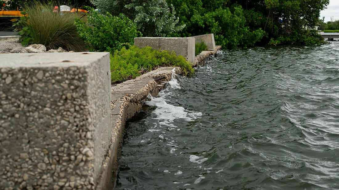 Waves lap against the weathered Bayfront Park seawall, which was installed before the town acquired the land to expand the park in 2011.